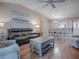 Open living space with vaulted ceilings, hardwood floors, and plenty of natural light at 616 Cokesbury Dr, The Villages, FL 32162