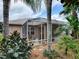 Landscaped backyard oasis with a screened patio for relaxing and entertaining at 616 Cokesbury Dr, The Villages, FL 32162
