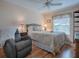 Cozy bedroom with a ceiling fan and recliner at 616 Cokesbury Dr, The Villages, FL 32162