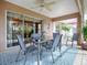 Enjoy dining alfresco in this screened patio with a ceiling fan at 616 Cokesbury Dr, The Villages, FL 32162