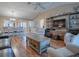 Spacious living room with hardwood floors and access to the dining area at 616 Cokesbury Dr, The Villages, FL 32162