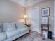 Light-filled home office with sofa, built-in shelving, and hardwood floors at 616 Cokesbury Dr, The Villages, FL 32162