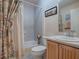 Clean bathroom with a tub shower combo and wood vanity at 616 Cokesbury Dr, The Villages, FL 32162
