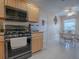 Kitchen with stainless steel appliances and light wood cabinets at 616 Cokesbury Dr, The Villages, FL 32162