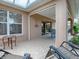 Outdoor patio with seating area and view into the house at 616 Cokesbury Dr, The Villages, FL 32162