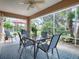 Relaxing screened patio with seating area and dining table, overlooking lush landscaping at 616 Cokesbury Dr, The Villages, FL 32162