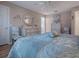 Bedroom with king-size bed, light wood furniture, and wood flooring at 616 Cokesbury Dr, The Villages, FL 32162
