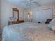 Bedroom with king-size bed, light wood furniture, and wood flooring at 616 Cokesbury Dr, The Villages, FL 32162