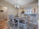Charming dining area with a rustic wooden table and six chairs at 616 Cokesbury Dr, The Villages, FL 32162