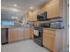 Well-equipped kitchen with wood cabinets, granite countertops, and stainless steel appliances at 616 Cokesbury Dr, The Villages, FL 32162