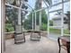 Enjoy the outdoors in this screened porch with comfortable seating at 616 Cokesbury Dr, The Villages, FL 32162