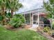 Lush tropical backyard with screened patio and plenty of plants at 616 Cokesbury Dr, The Villages, FL 32162