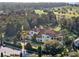 Luxury home with pool and expansive grounds, offering stunning views of the lake and surrounding landscape at 15008 Pendio Dr, Bella Collina, FL 34756