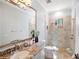 Bathroom with granite countertop, large mirror, and walk-in shower at 15008 Pendio Dr, Bella Collina, FL 34756