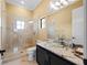 Modern bathroom with glass shower and a floating vanity at 15008 Pendio Dr, Bella Collina, FL 34756