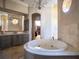 Bathroom features a large soaking tub, double vanity, and walk-in closet at 15008 Pendio Dr, Bella Collina, FL 34756