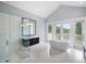 Spa-like bathroom with a soaking tub and dual vanities at 15008 Pendio Dr, Bella Collina, FL 34756