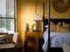 Bedroom features a gold accent table and a comfortable bed at 15008 Pendio Dr, Bella Collina, FL 34756