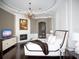 Luxurious bedroom with a plush bed, fireplace, and hardwood floors at 15008 Pendio Dr, Bella Collina, FL 34756