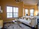Sitting area in bedroom with a comfortable sofa and glass coffee table at 15008 Pendio Dr, Bella Collina, FL 34756