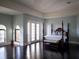 Main bedroom with a king-size bed and access to a balcony at 15008 Pendio Dr, Bella Collina, FL 34756