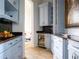 Well-appointed butler's pantry with wine cooler and ample storage at 15008 Pendio Dr, Bella Collina, FL 34756