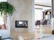 Modern fireplace with marble surround, adding a touch of elegance to the living space at 15008 Pendio Dr, Bella Collina, FL 34756