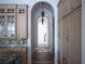 Elegant hallway with arched doorways and tile flooring at 15008 Pendio Dr, Bella Collina, FL 34756