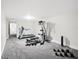 Spacious home gym with treadmill, weight machine, and free weights at 15008 Pendio Dr, Bella Collina, FL 34756