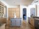 Spacious kitchen with large island, custom cabinetry, and granite counters at 15008 Pendio Dr, Bella Collina, FL 34756