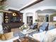 Bright living room featuring a kitchen view and ample seating at 15008 Pendio Dr, Bella Collina, FL 34756