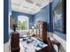 Bright living room with high ceilings, hardwood floors, and a large window at 15008 Pendio Dr, Bella Collina, FL 34756