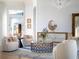 Bright and airy living room with comfortable seating, a statement chandelier and decorative accents at 15008 Pendio Dr, Bella Collina, FL 34756