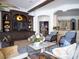 Open living room with built-in shelving and kitchen access at 15008 Pendio Dr, Bella Collina, FL 34756