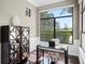 Home office with large window, hardwood floors, and built-in shelving at 15008 Pendio Dr, Bella Collina, FL 34756