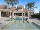 Luxury pool and spa with spacious patio and outdoor seating at 15008 Pendio Dr, Bella Collina, FL 34756