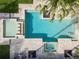 Aerial view of a large pool and spa with surrounding patio at 15008 Pendio Dr, Bella Collina, FL 34756