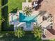 Overhead view of a luxurious pool and spa with stone patio at 15008 Pendio Dr, Bella Collina, FL 34756