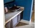 Elegant powder room with unique sink and dark blue walls at 15008 Pendio Dr, Bella Collina, FL 34756