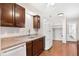 Kitchen with wood cabinets, granite countertops and white appliances at 613 W Oak Terrace Dr, Leesburg, FL 34748