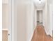 Hallway with light walls, wood flooring, and access to other rooms at 613 W Oak Terrace Dr, Leesburg, FL 34748