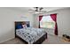 Bedroom with ceiling fan, window and dark wood bed frame at 736 Jones Ln, The Villages, FL 32163