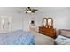 Bedroom features a dresser, ceiling fan and access to the bathroom at 736 Jones Ln, The Villages, FL 32163