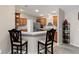 Kitchen with light wood cabinets, corner breakfast bar, and appliances at 736 Jones Ln, The Villages, FL 32163