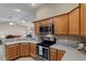 Modern kitchen with stainless steel appliances and light wood cabinets at 736 Jones Ln, The Villages, FL 32163