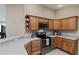 Modern kitchen with stainless steel appliances and light wood cabinets at 736 Jones Ln, The Villages, FL 32163