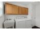 Laundry room with washer, dryer, and cabinets at 736 Jones Ln, The Villages, FL 32163