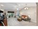 Spacious living room with a large sofa, coffee table, and sliding glass door at 736 Jones Ln, The Villages, FL 32163