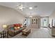 Comfortable living room with a brown couch and access to kitchen and other rooms at 736 Jones Ln, The Villages, FL 32163