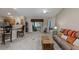 Open living room with kitchen views, a comfy sofa, and sliding glass doors at 736 Jones Ln, The Villages, FL 32163